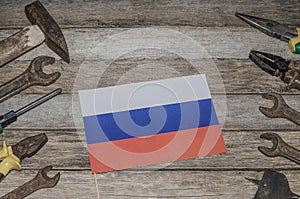 Labor Day in Russia, May 1. A lot of handy tools on an old wooden background with the flag of Russia with copy space