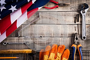 Labor Day, USA America flag with many handy tools on wooden background texture