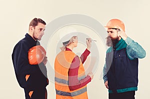 Labor dispute concept. Builders and engineer arguing, misunderstanding.