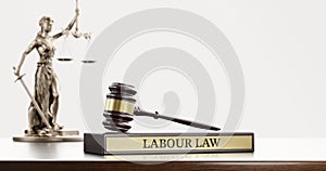 Labor Law: Judge& x27;s Gavel as a symbol of legal system, Themis is the goddess of justice and wooden stand with text