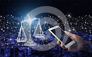 Labor Law Lawyer Legal Business. Hand hold white smartphone with digital hologram sign on city dark blurred background. Libra