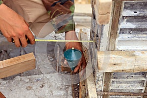 Labor man using a plumb bob for check