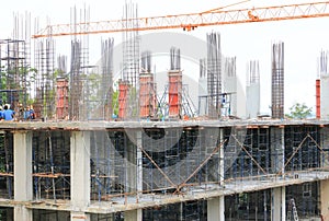 Labor working and Crane hook in big construction site in develop city