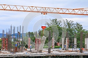 Labor working and Crane hook in big construction site in develop city