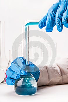 Laboratorian pours reagent in the flask