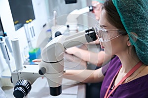 Laboratories at the workplace look through microscopes
