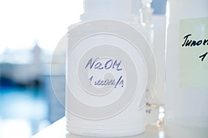 Laboratory for analysis of NaOH in a plastic container flask