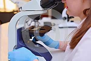 Laboratory assistant with a microscope. Medical laboratory for the study of analyzes