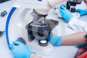 Laboratory assistant with a microscope. Medical laboratory for the study of analyzes