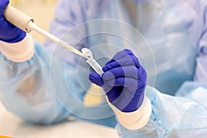 Laboratory assistant with a pipette in his hands for blood testing