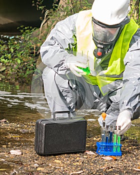 Laboratory assistant in a protective suit and mask with a mini laboratory conducts an express test at the site of the alleged