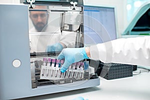 Putting test tubes into the analyzer machine