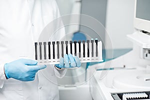 Laboratory assistant with test tubes in the laboratory