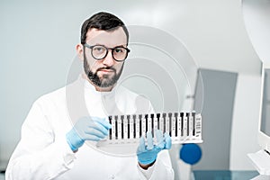 Laboratory assistant with test tubes in the laboratory
