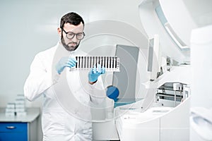 Laboratory assistant with test tubes in the laboratory