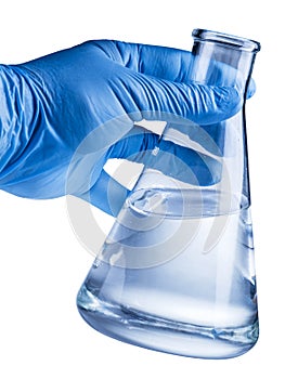 Laboratory beaker in analyst`s hand in plastic glove.