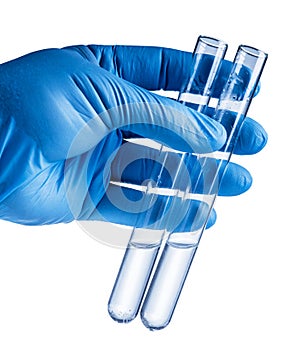 Laboratory beakers in analyst`s hand in plastic glove.