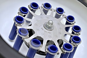 Laboratory centrifuge with empty tube compartments. Side view at an angle to the open interior