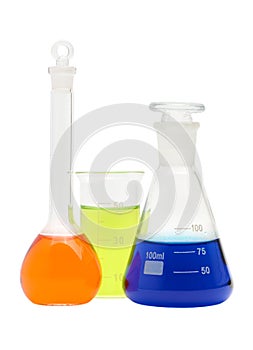 Laboratory conical flasks and beaker with colored liquid reagents isolated on white background, close up