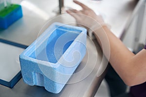 Laboratory employee works with biomaterial for immersion in liquid nitrogen