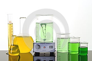 Laboratory equipment. Beakers, erlenmeyer flasks and magnetic stirrer photo