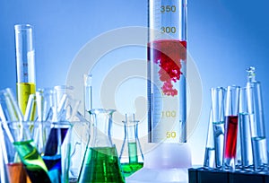 Laboratory equipment, bottles filled with colorful liquids, red liquid reacted