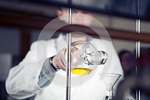 Laboratory equipment for distillation.Separating the component substances from liquid mixture.Pharmaceutical researcher holding Er