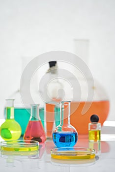 Laboratory flasks and beakers with liquids of different colors on lab table