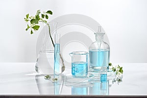 Laboratory glass equipment with natural ingredients on white background