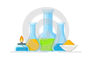 Laboratory glass flasks and test tubes with blue, yellow and green liquid.