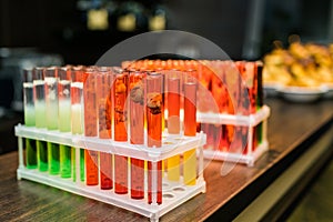 Laboratory glassware with alcohol cocktail's on chemical party