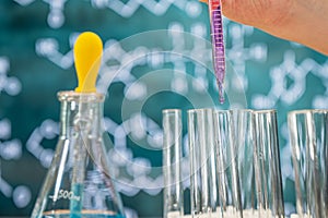 Laboratory glassware with blackboard background with various chemical formulas