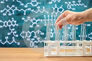 Laboratory glassware with blackboard background with various chemical formulas