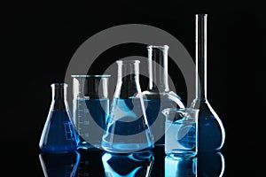 Laboratory glassware with blue liquids