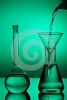 Laboratory glassware on color background