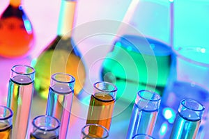 Laboratory glassware with colorful chemicals, chemistry science photo