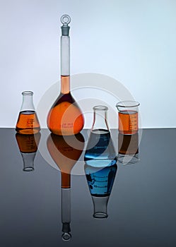 Laboratory glassware containing colored solutions