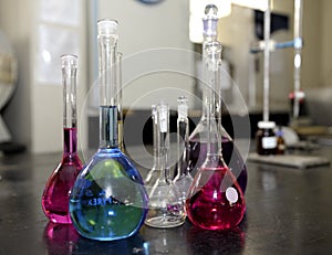 Laboratory glassware containing colorful chemical liquid, lab research and development concept