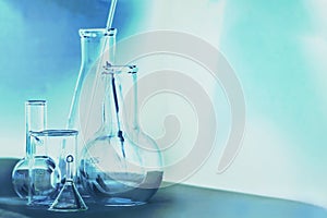 Laboratory glassware in dark blue colors and white background