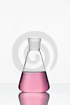 Laboratory Glassware. Glass With Pink Liquid On White Background