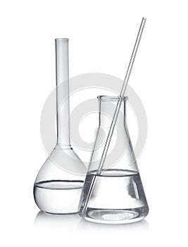 Laboratory glassware with liquid samples on background
