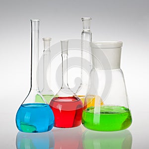 Laboratory glassware with liquids of different colors