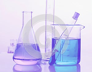 Laboratory bottles - test tubes and beakers - on white