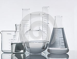 Laboratory bottles - test tubes and beakers - on white
