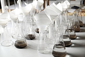 Laboratory glassware with soil extracts and funnels