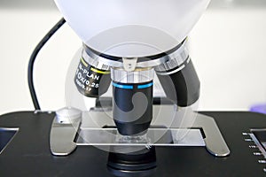 Laboratory microscope with different lenses closeup. Scientific and healthcare research background