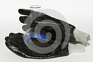 Laboratory research concept - flask of blue crystal in the gloves