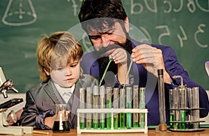 laboratory research and development. bearded man teacher with little boy. Laboratory test tubes and flasks with liquids