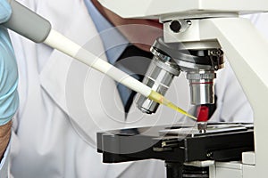 Laboratory scientist looking into microscope