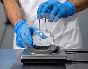 Laboratory Scientist Weighing Sample Using Precision Scale